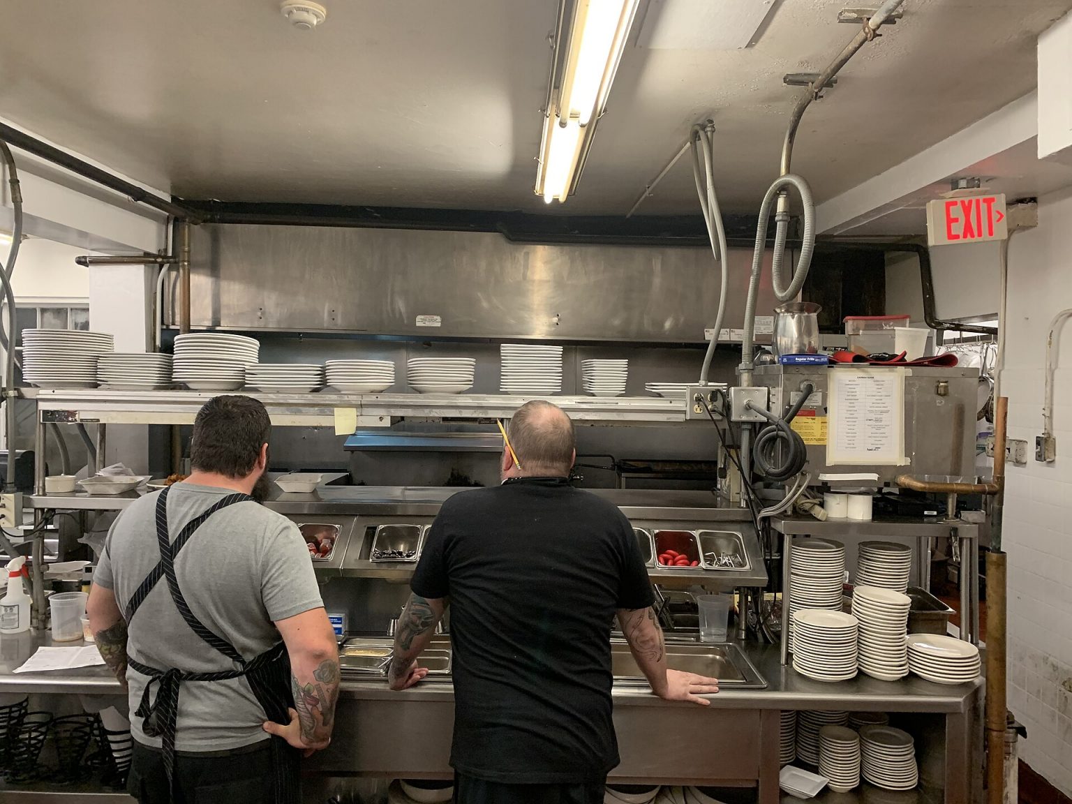 Stainless-steel commercial kitchen with extraction canopy