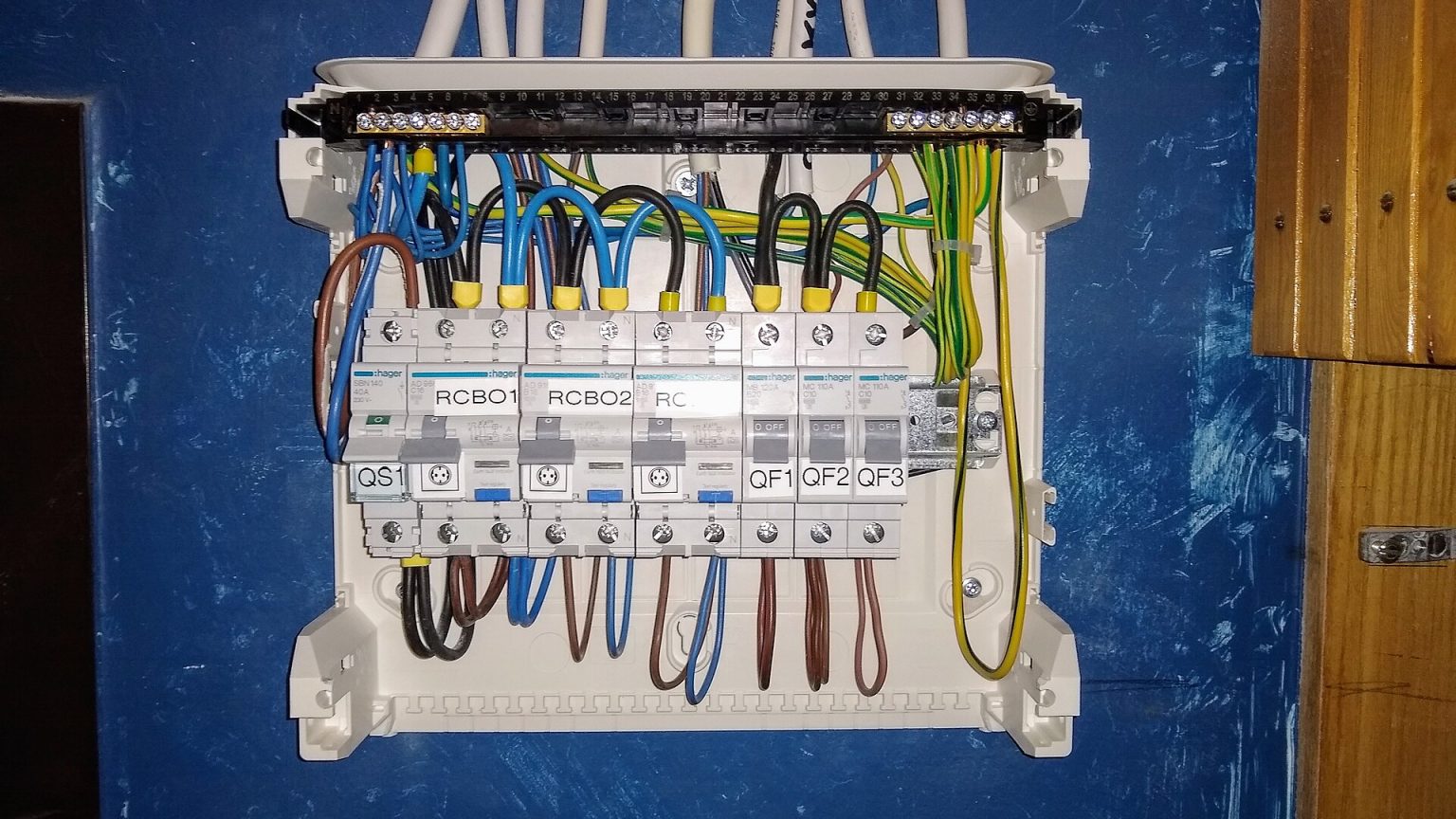 Electrician working on a consumer unit to BS 7671